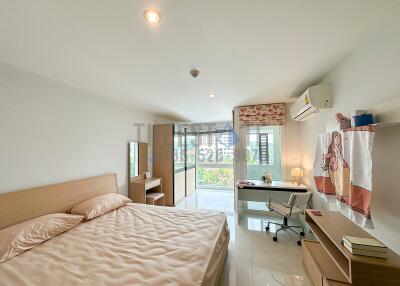 Spacious bedroom with large window and study area