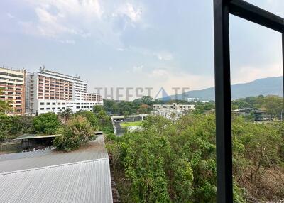 Scenic view from balcony or window with buildings and greenery