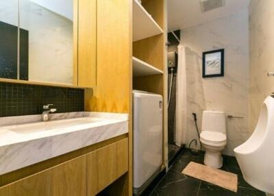 Modern bathroom with vanity, toilet, and urinal