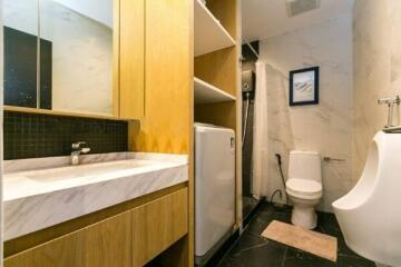 Modern bathroom with vanity, toilet, and urinal