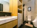 Modern bathroom with vanity, toilet, and urinal