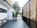 Outdoor balcony with seating area and potted plants