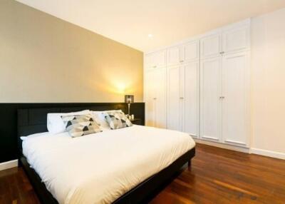 Spacious modern bedroom with comfortable bed and ample closet space