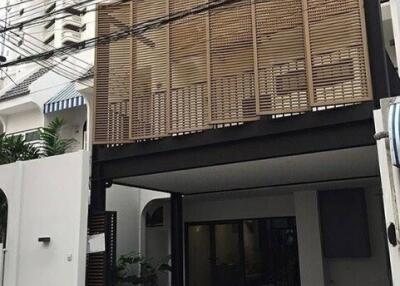 Front view of a modern house with wooden screen facade