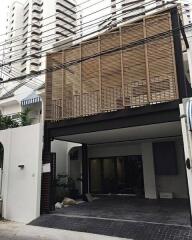 Front view of a modern house with wooden screen facade