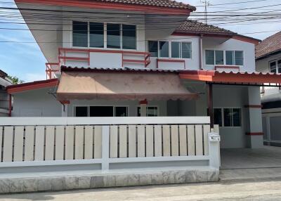 Front exterior view of a two-story house with gated fence