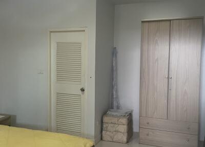 Bedroom with wardrobe, bed, and door