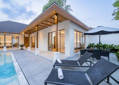 Modern house with poolside seating and outdoor dining area