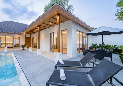 Modern house with poolside seating and outdoor dining area