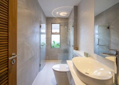 Modern bathroom with shower, sink, and toilet