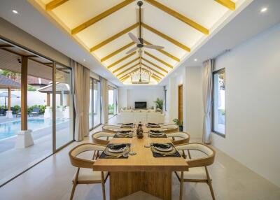 Elegant open-plan living and dining area with pool view