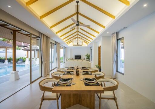 Elegant open-plan living and dining area with pool view