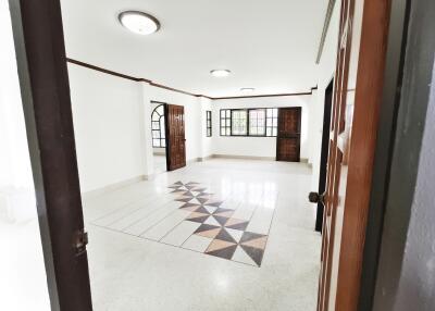 Spacious living area with tiled flooring and large windows