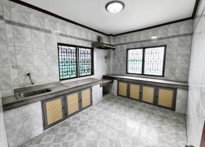 Modern kitchen with tiled walls and floors