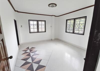 Spacious empty bedroom with windows