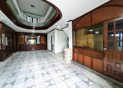 Spacious hallway with tiled floors and wooden detailing