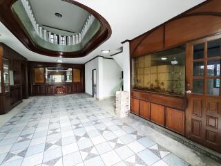 Spacious hallway with tiled floors and wooden detailing