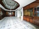 Spacious hallway with tiled floors and wooden detailing