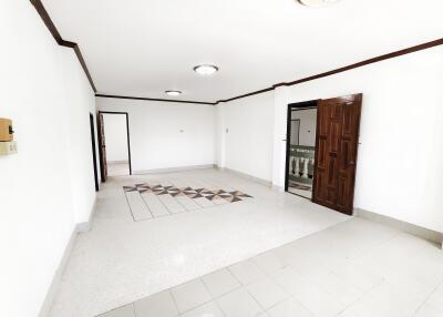 Spacious living room with polished tiles and wood accents