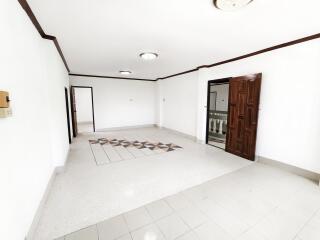 Spacious living room with polished tiles and wood accents