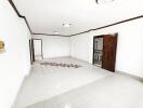 Spacious living room with polished tiles and wood accents