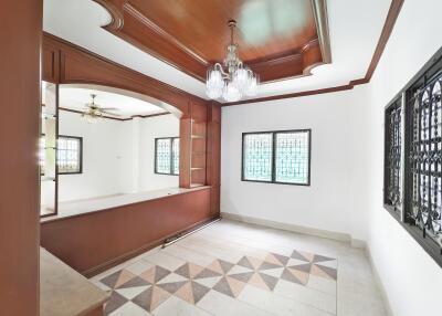 Spacious living room with decorative ceiling and chandelier