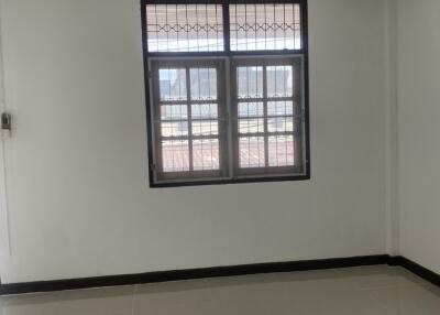 Empty bedroom with tiled floor and window