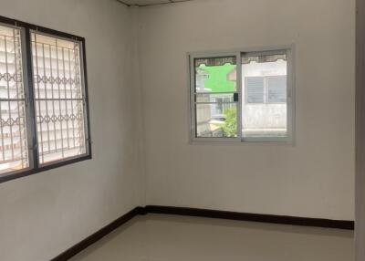 Empty bedroom with tiled floor and ceiling lights