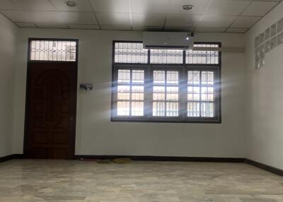 Unfurnished living room with tiled floor and large windows