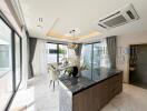 Modern kitchen and dining area with island and large windows