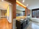 Modern bathroom with dual sinks, bathtub, and walk-in closet