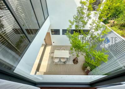 Top view of an outdoor patio with a dining table and chairs