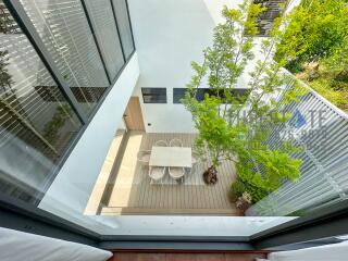 Top view of an outdoor patio with a dining table and chairs