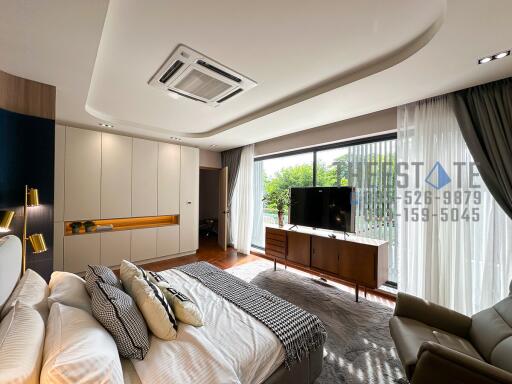 Modern bedroom with large windows and contemporary furniture