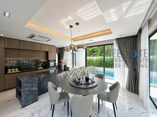 Modern kitchen and dining area with pool view