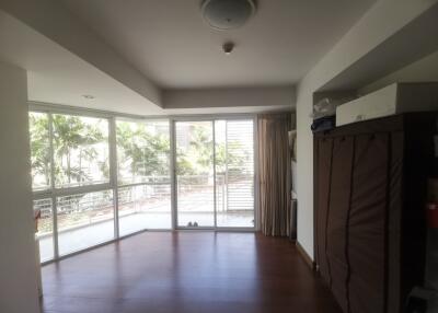 Spacious bedroom with large windows and balcony