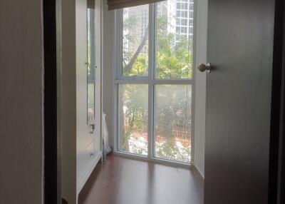 Hallway with large window and wooden floor