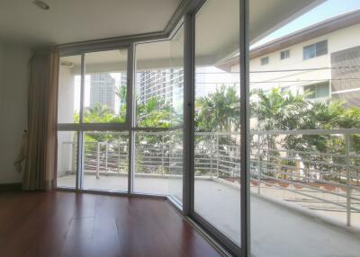 Spacious living room with large glass doors leading to balcony