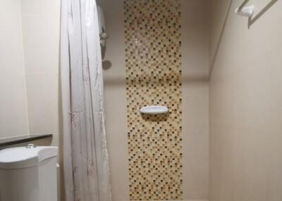 Modern bathroom with shower curtain and mosaic tiles