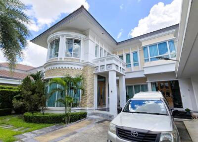 Front view of a modern house with a car parked in the driveway