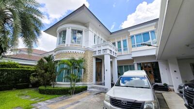 Front view of a modern house with a car parked in the driveway