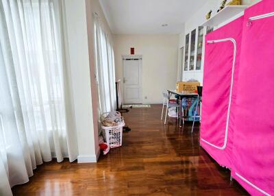 Bright hallway with wood flooring and white curtains