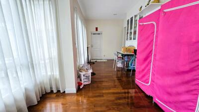 Bright hallway with wood flooring and white curtains