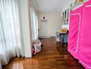 Bright hallway with wood flooring and white curtains