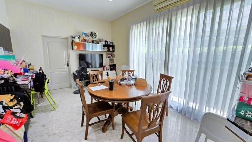 Dining room with wooden table, chairs, and large window