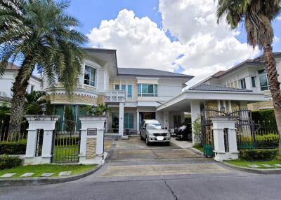 Exterior view of a modern house with a driveway and landscaped front yard