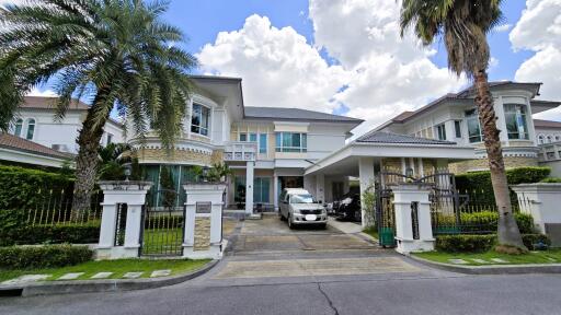 Exterior view of a modern house with a driveway and landscaped front yard