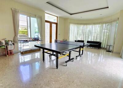 Spacious living room with ping pong table and seating area