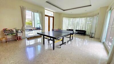 Spacious living room with ping pong table and seating area