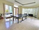 Spacious living room with ping pong table and seating area